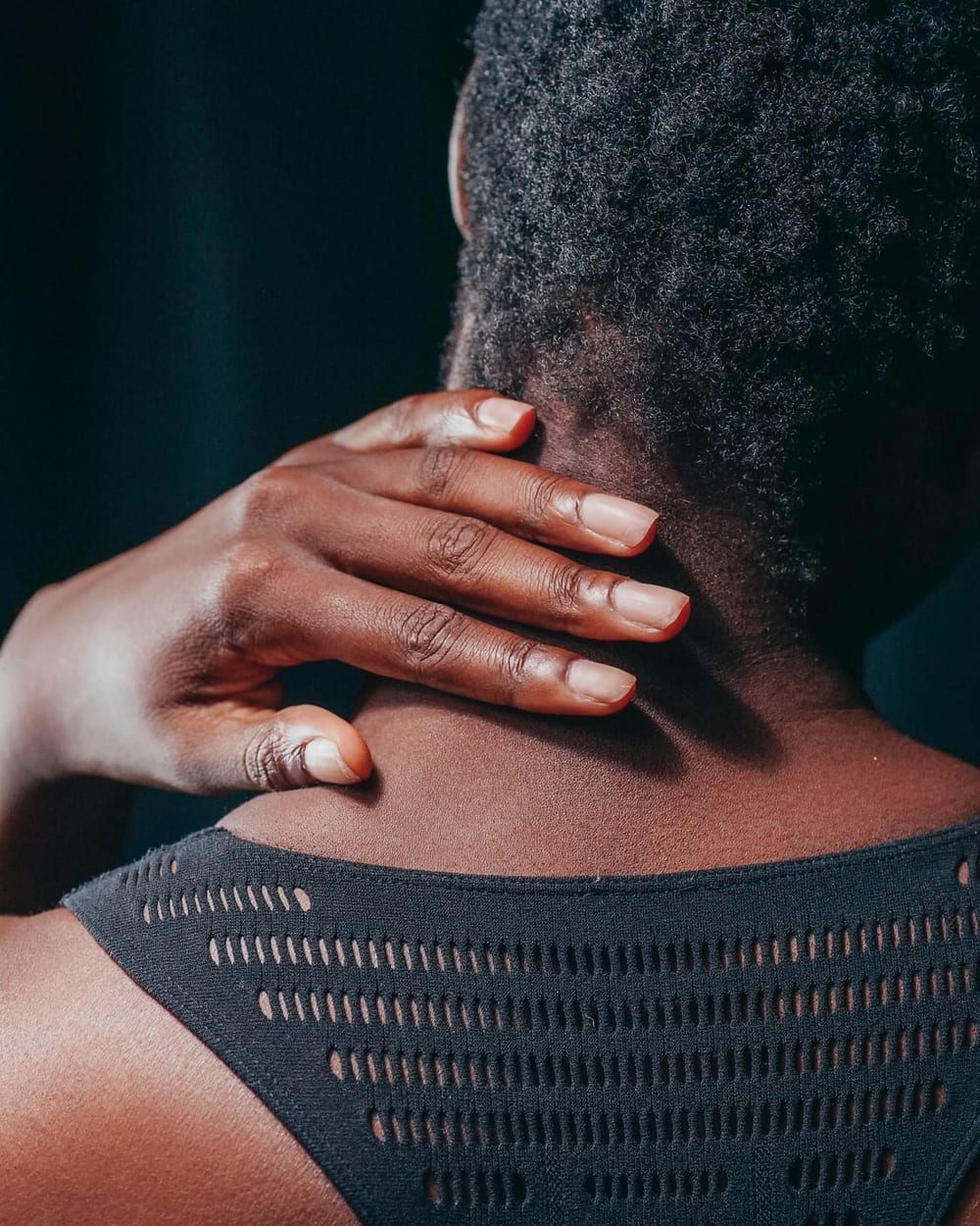 Woman holding the back of her neck