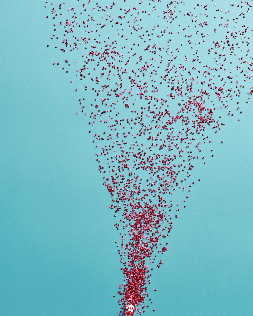 Red dots forming a stream against a blue background